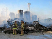 Firefighters react to a fire during the Adell Co-op.