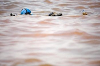 Ocean Futures Society’s Director of photographer Matthew Ferraro movies a Portuguese Man O’ War in oil and dispersant slick following spill. Picture credit: © Carrie Vonderhaar, Ocean Futures Society