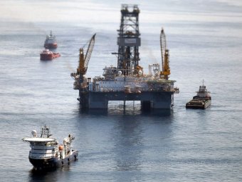 PHOTO: Ships work close to the website for the BP Deepwater Horizon oil spill on August 3, 2010, inside Gulf of Mexico from the shore of Louisiana.