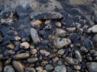 PICTURE: Spilled oil covers the beach at Refugio State Beach on May 19, 2015 north of Goleta, Calif.