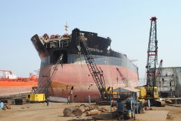 Ship becoming dismantled on a beach in Asia.